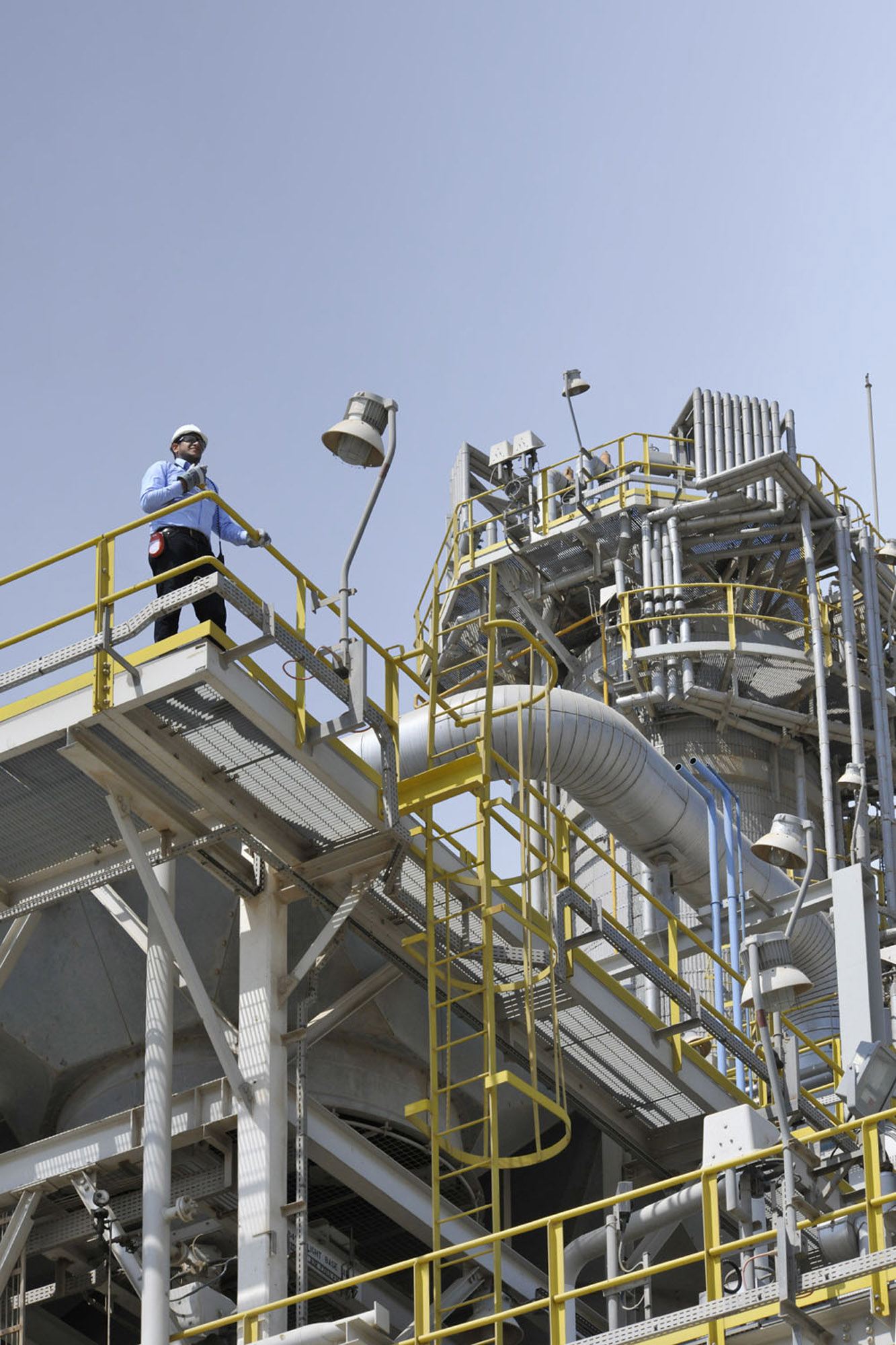 Engineer inspecting a process unit platform